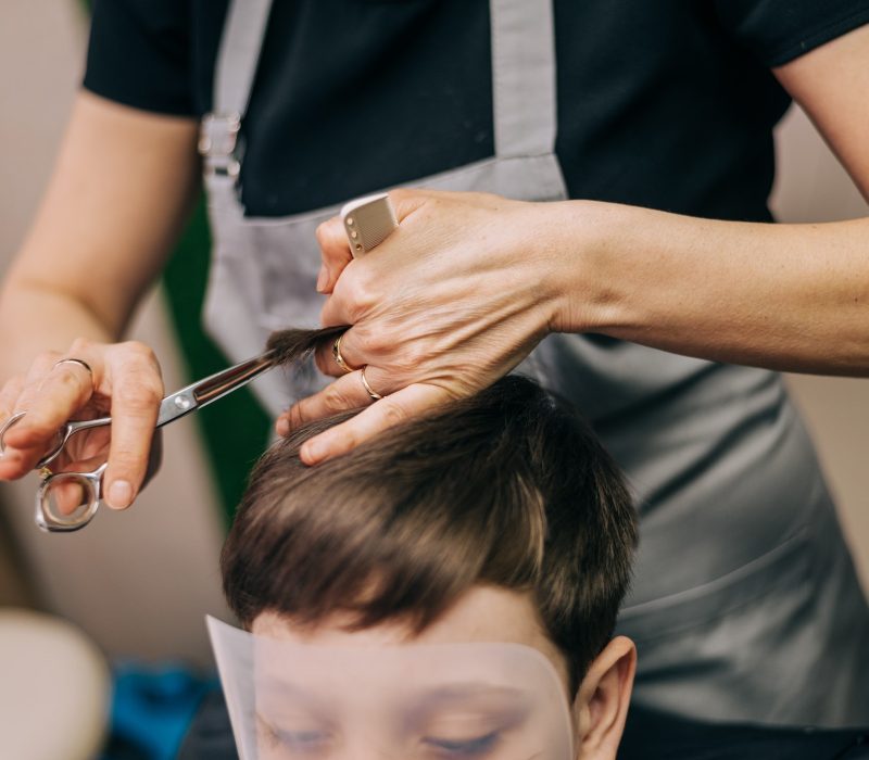 little-kid-boy-in-the-barbershop-or-hairdressing-saloon-barber-is-doing-haircut-for-a-toddler.jpg